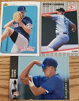 Front view of three baseball cards showing player images and titles