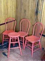 three spindle back chairs and stool grouped together