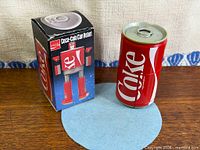 Box beside can-form robot showing branding and scale