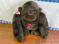 Front view of brown gorilla plush with tags visible