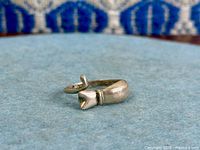 Side view of sterling silver cat ring showing open band and cat head