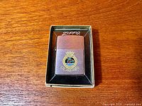 Lighter in box, crest visible