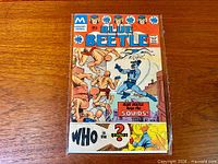 Front cover of bagged Blue Beetle #1 comic showing art and 35¢ price