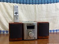 Front view of stereo system with speakers and remote