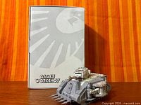 Front view of partially assembled Chaos Predator beside Games Workshop box