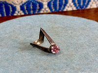 Full view of V-shaped sterling silver ring with purple stone