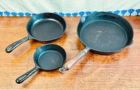 Top view showing three cast iron skillets