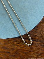 Close-up of ball chain links on necklace