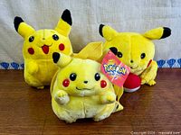 Three Pikachu plush items grouped