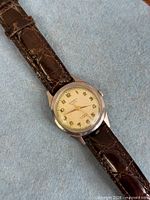 Front view showing dial, case and strap