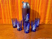 Entire barware set showing cocktail shaker and five tumblers