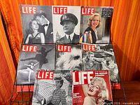 All eight Life magazines arranged on rack, full frontal view