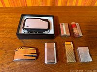 All seven lighters laid out, showing variety