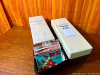 Two plastic View-Master storage cases and open case showing numerous reel packets