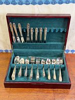 Overall view of flatware set in open chest