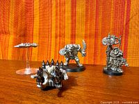 group shot of all four miniatures on wood surface