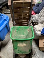 Front view of Garden Club drop spreader showing hopper, wheels and handle