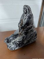 Three-quarter side view of the soapstone figurine