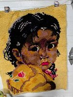 Full view of latch hook tapestry showing child portrait