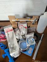 Group view of all plumbing parts and tools on table