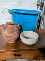All three items together: blue tub, terracotta vase, white planter