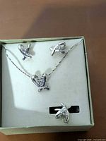 Full view of necklace, earrings, ring in presentation box