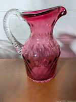 Full view of cranberry glass pitcher vase