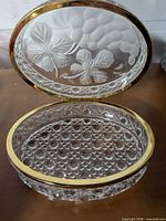 Box open showing lattice-cut interior and frosted lid design