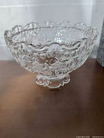 Full view of clear pressed glass pedestal candy dish