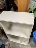 Front angled view of white two-tier laminate bookcase