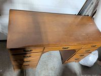 Overall view of wooden desk top and pedestals