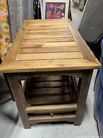 Full view of wooden slat end table with lower shelf