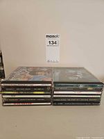Two stacks totaling 14 rock CDs in jewel cases