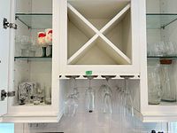 cabinet view showing wine glasses, pitcher, carafe