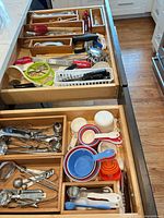 Open drawers showing full assortment of utensils, organizers and measuring tools
