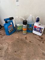 Group shot of five outdoor cleaning products with sprayer attachments and aerosol can