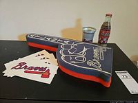 Foam finger, Coke bottle, aluminum cup, Braves stickers displayed