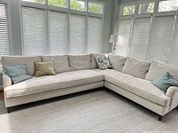 Full view of L-shaped sectional sofa with pillows