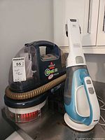 Both cleaning appliances side by side showing overall condition and included hose