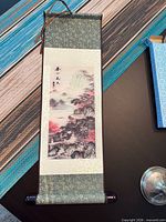 Full view of hanging scroll showing brocade mount, artwork panel and wood ends