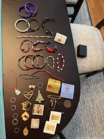 Overall view of entire jewelry lot laid out on table