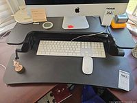 Front view of FlexiSpot desk converter holding monitor and keyboard