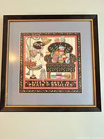 Full view of framed cross-stitch artwork