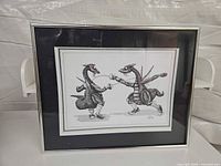 Front view of framed dragon fencing print in silver frame