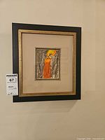 Front view of framed artwork hanging on wall