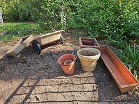 Wide shot showing cart, soil sifter and group of planters