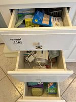 Three-drawer unit with visible oral irrigator and supplies