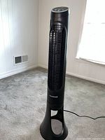 Full view of the Honeywell tower fan standing on carpeted floor