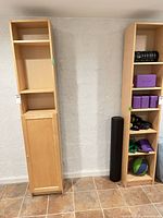 Full view of both tall narrow Ikea bookshelf cabinets side by side