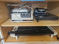 Cabinet shelf with all four appliances visible